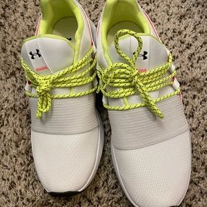 Under armour tennis shoe. Cut small.